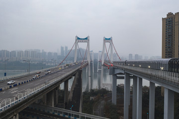 Aerial drone shot of flyover highway to E'GongYan Bridge with Chinese name on the bridge in Chongqing, China