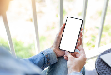 cell phone Mockup image blank white screen.woman hand holding texting using mobile on desk at coffee shop.background empty space for advertise text.people contact marketing business,technology