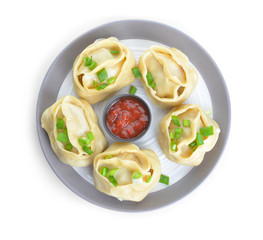 Plate with oriental dumplings and sauce on white background
