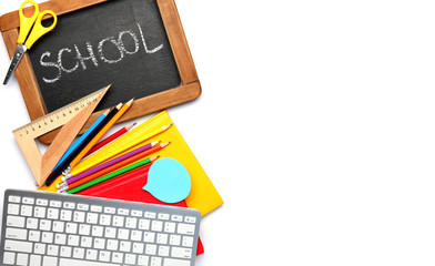 Set of supplies with computer keyboard and chalkboard on white background