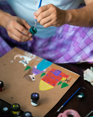 Bangi, Malaysia - Mar 27, 2020: art, creativity and people concept - hand of artist with brush painting picture