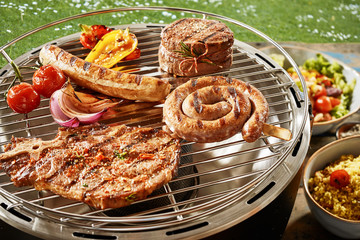 Assorted grilled meat on a gas barbecue
