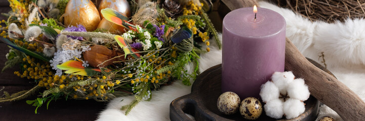 Fototapeta premium Easter still life with candles and easter decoration. Easter holiday concept. Close-up.