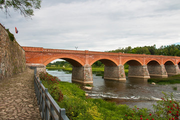 the widest waterfall in Europe, Kuldiga, Latvia. With an old brick bridge across the Venta River