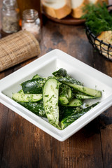 Pickles served in a white square plate