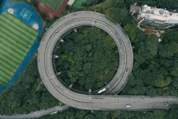 Aerial overhead shot of particular double circle 720 degree flyover in bushes residential buildings in Chongqing, southwest China