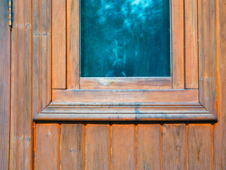 Small window in wooden wall