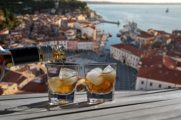 Drink for two on a terrace overlooking a small town on the Croatian coast. Two glasses of liquor...