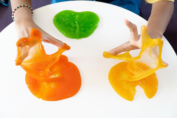 Hand Holding Homemade Toy Called Slime, Kids having fun and being creative by science experiment