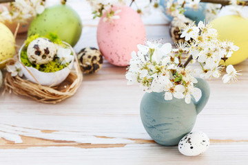Obraz na płótnie Canvas Basket with Easter eggs and cherry blossom branch.
