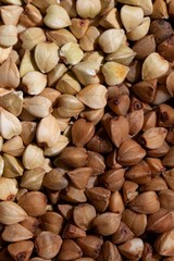 Solid background of raw and fried buckwheat macro
