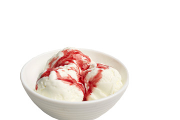 balls of white vanilla ice cream with red berry syrup in a white bowl on a white background.
