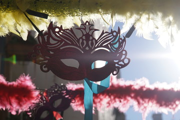 Street decoration with colorful garlands, face mask and sunflares