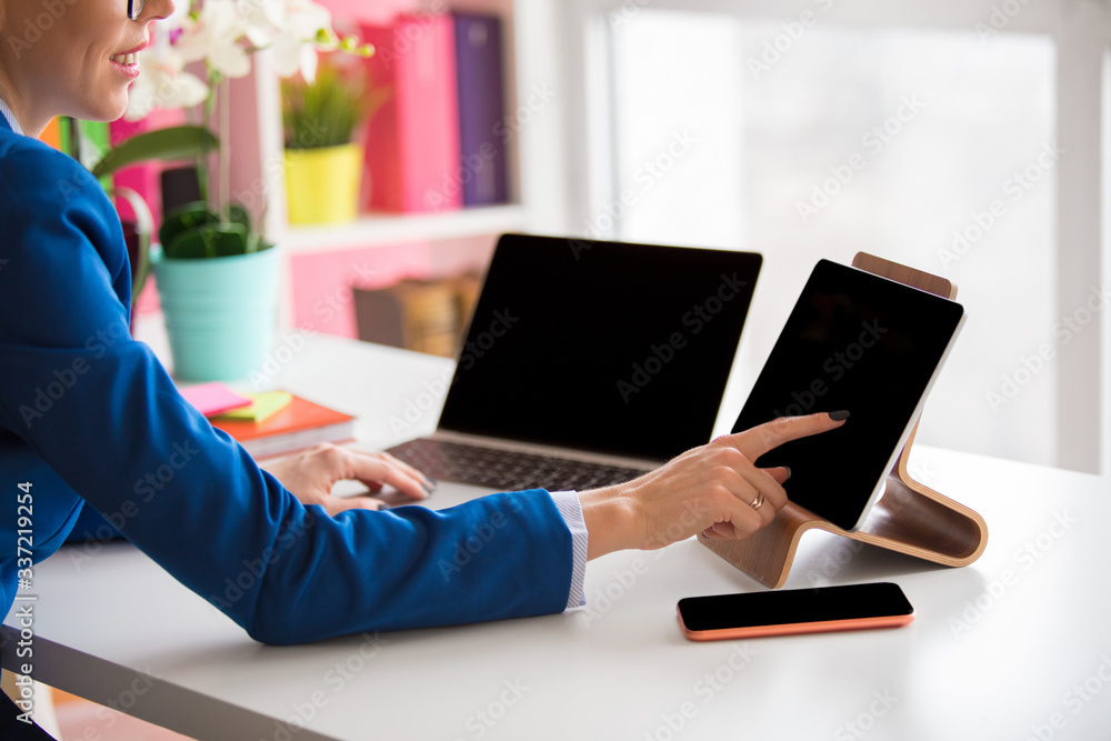 Poster woman working in the office and using different tech devices