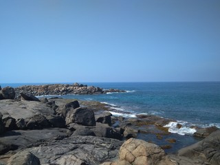 Fototapeta na wymiar coaslandscape, water, ocean, sky, rock, rocks, nature, blue, waves, travel, stone, coastline, blue sky