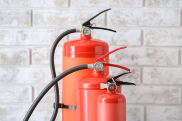 Fire extinguishers near light wall