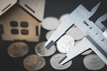 Russian ruble coin in a caliper, business concept for measuring profit and loss, selective focusing