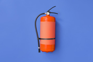Fototapeta premium Fire extinguisher on color background
