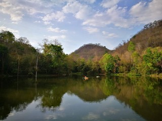 Fototapeta na wymiar Reflection Of Trees In Lake Against Sky