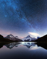 Incredible night view of Bachalpsee lake in Swiss Alps mountains. Snowy peaks of Wetterhorn,...