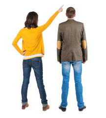 Back view of couple in sweater pointing.