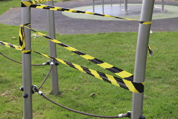 Fototapeta na wymiar public play area and park land taped off to stop use during coronavirus pandemic