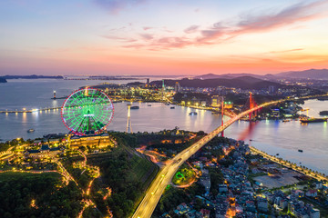 Panorama of Ha Long City, Vietnam, with Bai Chay bridge. Near Halong Bay, UNESCO World Heritage Site. Popular landmark, famous destination of Vietnam. View from center city to Ha Long bay.