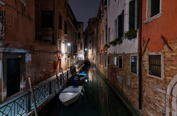 Obraz na płótnie Canvas Venice, Italy - February 18, 2020: view into a small canal in Venice at night 