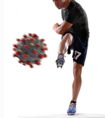Soccer player kicking away the coronavirus molecule.