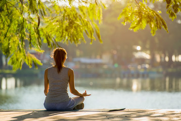 Young woman doing yoga in morning park