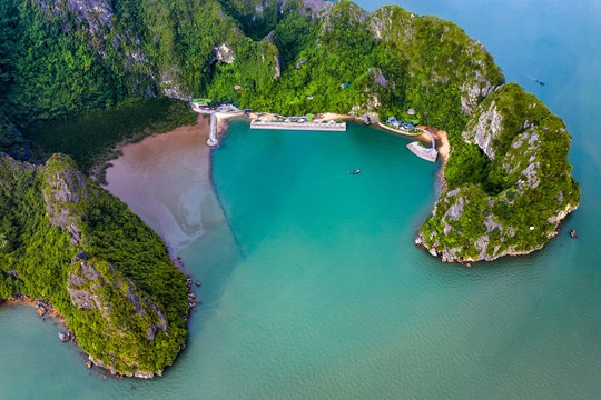 Aerial view Dau Go cave at Ba Hang floating fishing village, rock island, Halong Bay, Vietnam, Southeast Asia. UNESCO World Heritage Site. Junk boat cruise to Ha Long Bay.Famous destination of Vietnam