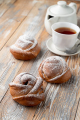 Traditional russian buns with sweet filling, close up shot on old wooden table