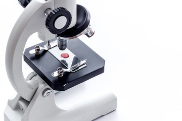 Microscope medical reserch. Blood sample for analysis. White table copy space