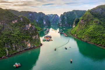 Aerial view of Cua Van floating fishing village and rock island, Halong Bay, Vietnam, Southeast Asia. UNESCO World Heritage Site. Junk boat cruise to Ha Long Bay. Famous destination of Vietnam © Hien Phung