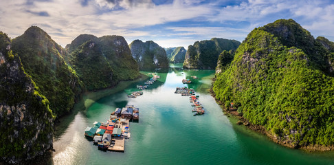 Aerial view of Cua Van floating fishing village and rock island, Halong Bay, Vietnam, Southeast Asia. UNESCO World Heritage Site. Junk boat cruise to Ha Long Bay. Famous destination of Vietnam - obrazy, fototapety, plakaty