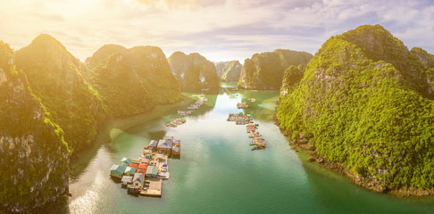 Aerial view of Cua Van floating fishing village and rock island, Halong Bay, Vietnam, Southeast Asia. UNESCO World Heritage Site. Junk boat cruise to Ha Long Bay. Famous destination of Vietnam © Hien Phung