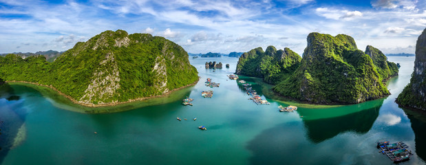 Aerial view of Cua Van floating fishing village and rock island, Halong Bay, Vietnam, Southeast Asia. UNESCO World Heritage Site. Junk boat cruise to Ha Long Bay. Famous destination of Vietnam © Hien Phung