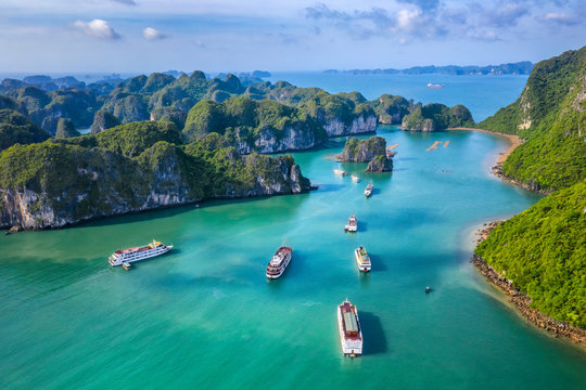 Aerial view Vung Vieng floating fishing village and rock island, Halong Bay, Vietnam, Southeast Asia. UNESCO World Heritage Site. Junk boat cruise to Ha Long Bay. Famous destination of Vietnam