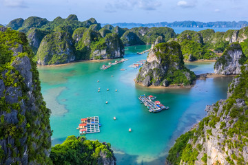 Aerial view Vung Vieng floating fishing village and rock island, Halong Bay, Vietnam, Southeast Asia. UNESCO World Heritage Site. Junk boat cruise to Ha Long Bay. Famous destination of Vietnam © Hien Phung