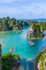 Aerial view Vung Vieng floating fishing village and rock island, Halong Bay, Vietnam, Southeast Asia. UNESCO World Heritage Site. Junk boat cruise to Ha Long Bay. Famous destination of Vietnam