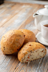 Onion bread sliced in halves, with its fluffy texture visible, close up shot on wooden table