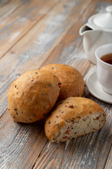 Onion bread sliced in halves, with its fluffy texture visible, close up shot on wooden table