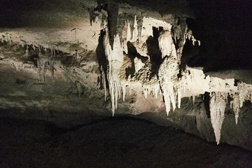 Beautiful colorful and illuminated cave with stalactites and stalagmites
