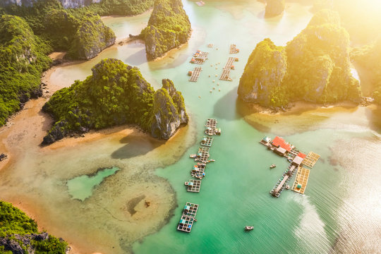 Aerial view Vung Vieng floating fishing village and rock island, Halong Bay, Vietnam, Southeast Asia. UNESCO World Heritage Site. Junk boat cruise to Ha Long Bay. Famous destination of Vietnam