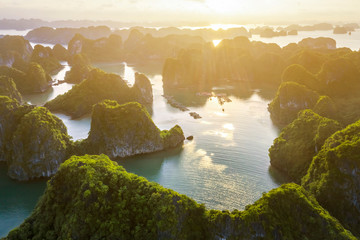 Aerial view Vung Vieng floating fishing village and rock island, Halong Bay, Vietnam, Southeast Asia. UNESCO World Heritage Site. Junk boat cruise to Ha Long Bay. Famous destination of Vietnam © Hien Phung