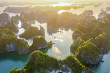 Aerial view Vung Vieng floating fishing village and rock island, Halong Bay, Vietnam, Southeast Asia. UNESCO World Heritage Site. Junk boat cruise to Ha Long Bay. Famous destination of Vietnam © Hien Phung