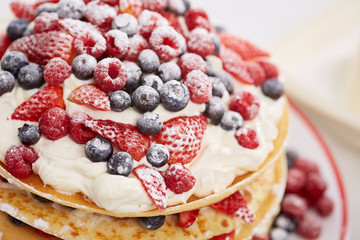 Pancakes with berries and sugar.