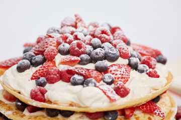 Pancakes with berries and sugar.