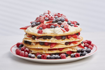 Pancakes with berries and sugar.
