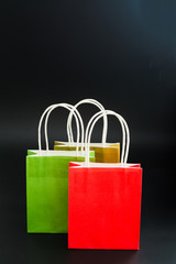 Paper shopping bags on black background with copy space